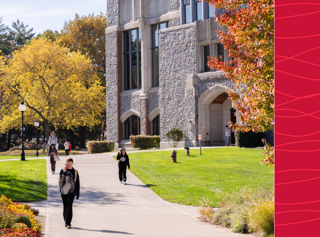 Students walking on campus in fall.