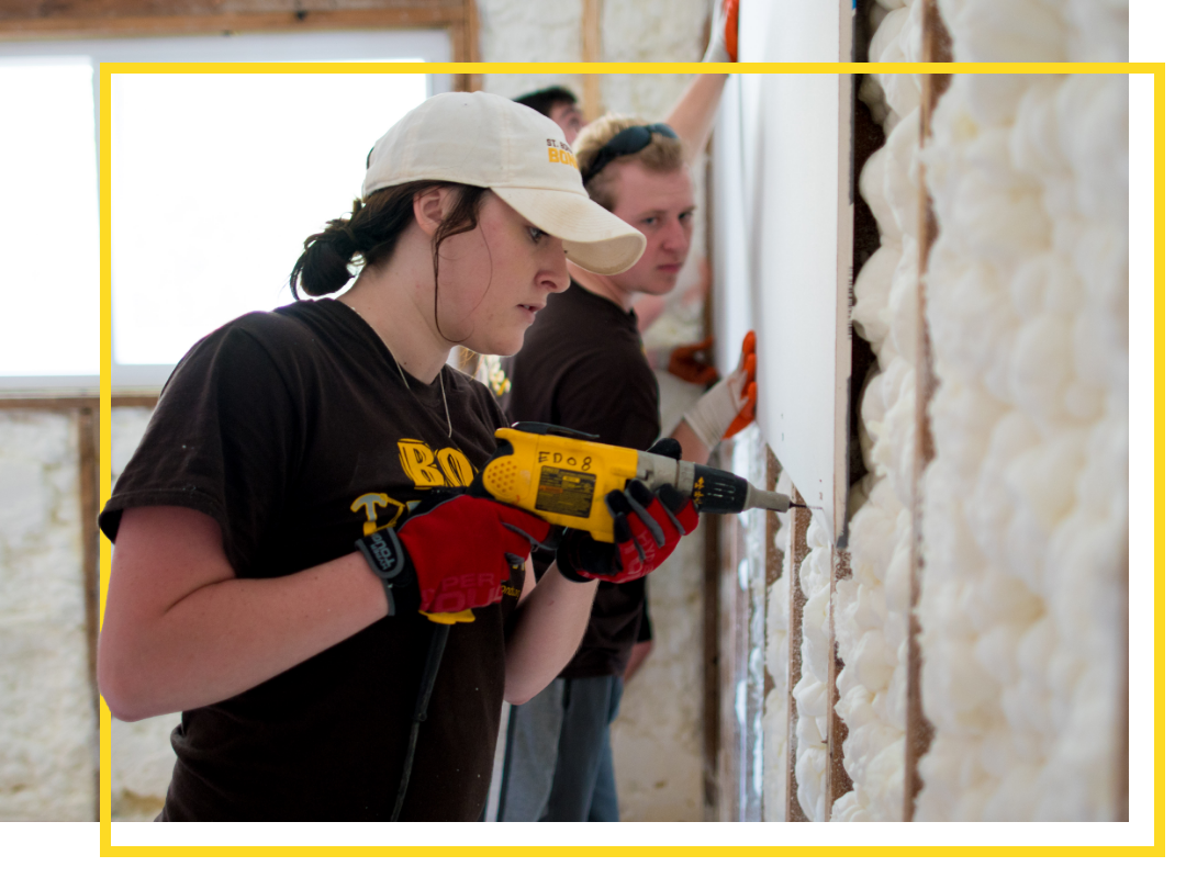 A Bonnie using power tools at a community service project
