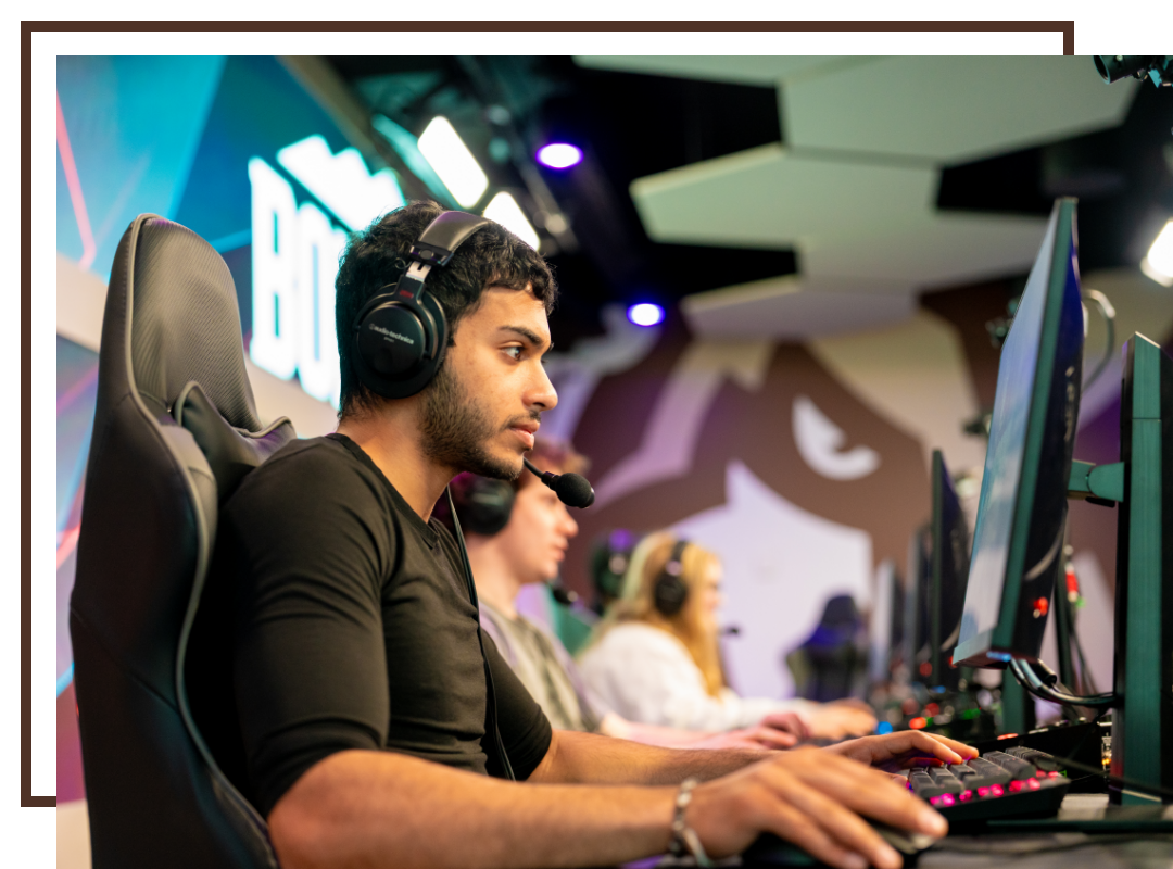 A Bonnie gaming in the new esports facility on campus