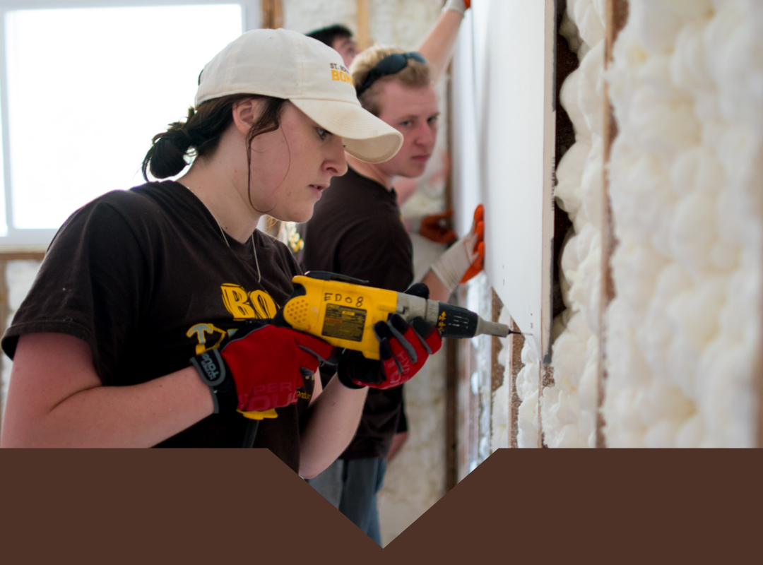 A Bonnie using power tools at a community service project