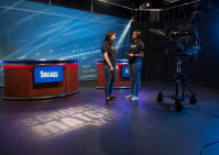 Two students on TV set. 