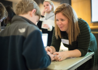 Teacher works with student on project. 